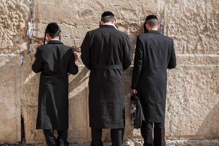 An image of jewish men doing the Oseh Shalom Prayer